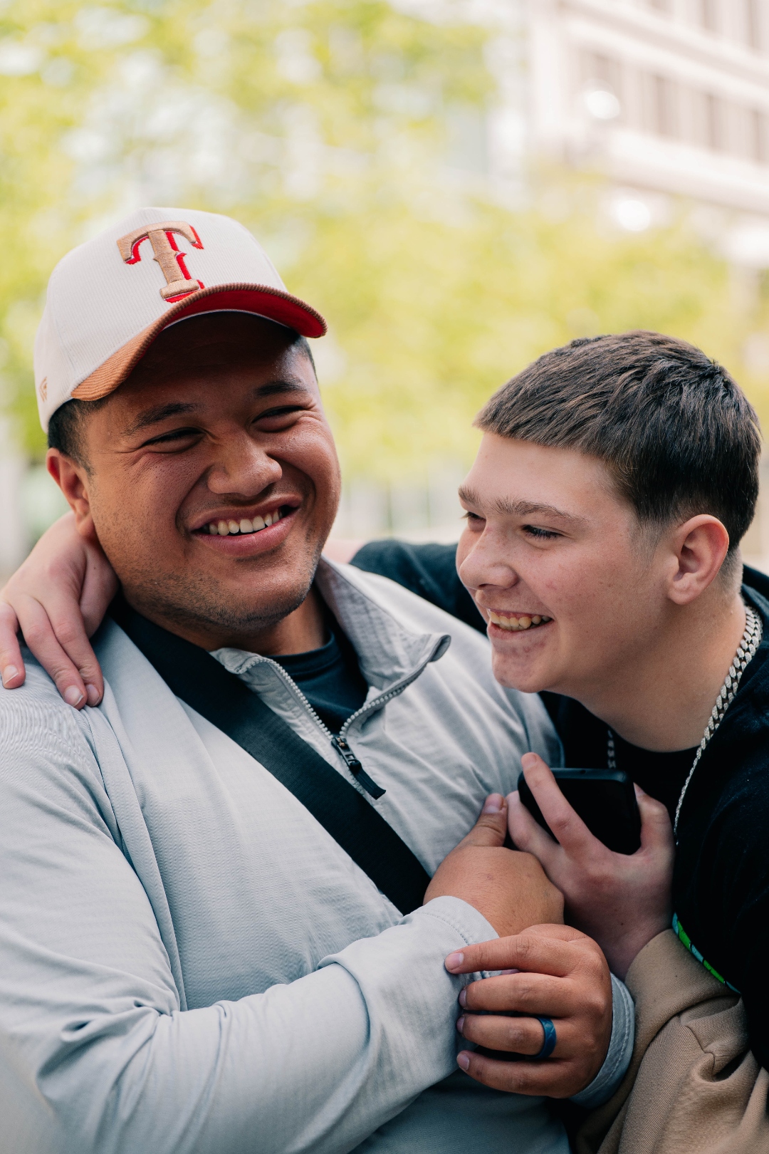 FaleOfaz staff member and client laughing together with arms around each other